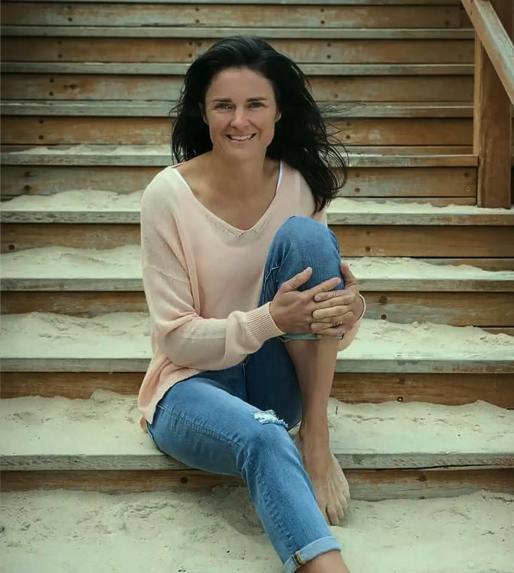Anna Baylis sitting on the stairs sharing her inspirational journey supporting Mental Health